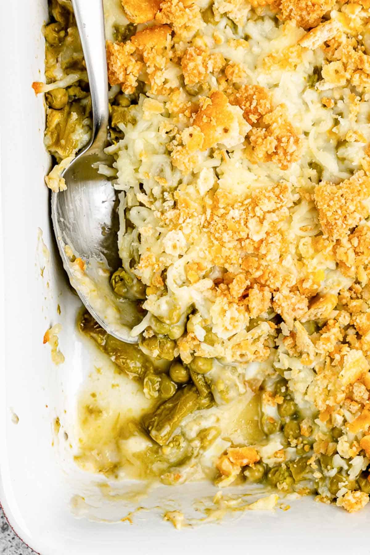 Canned asparagus casserole with peas in a baking dish.