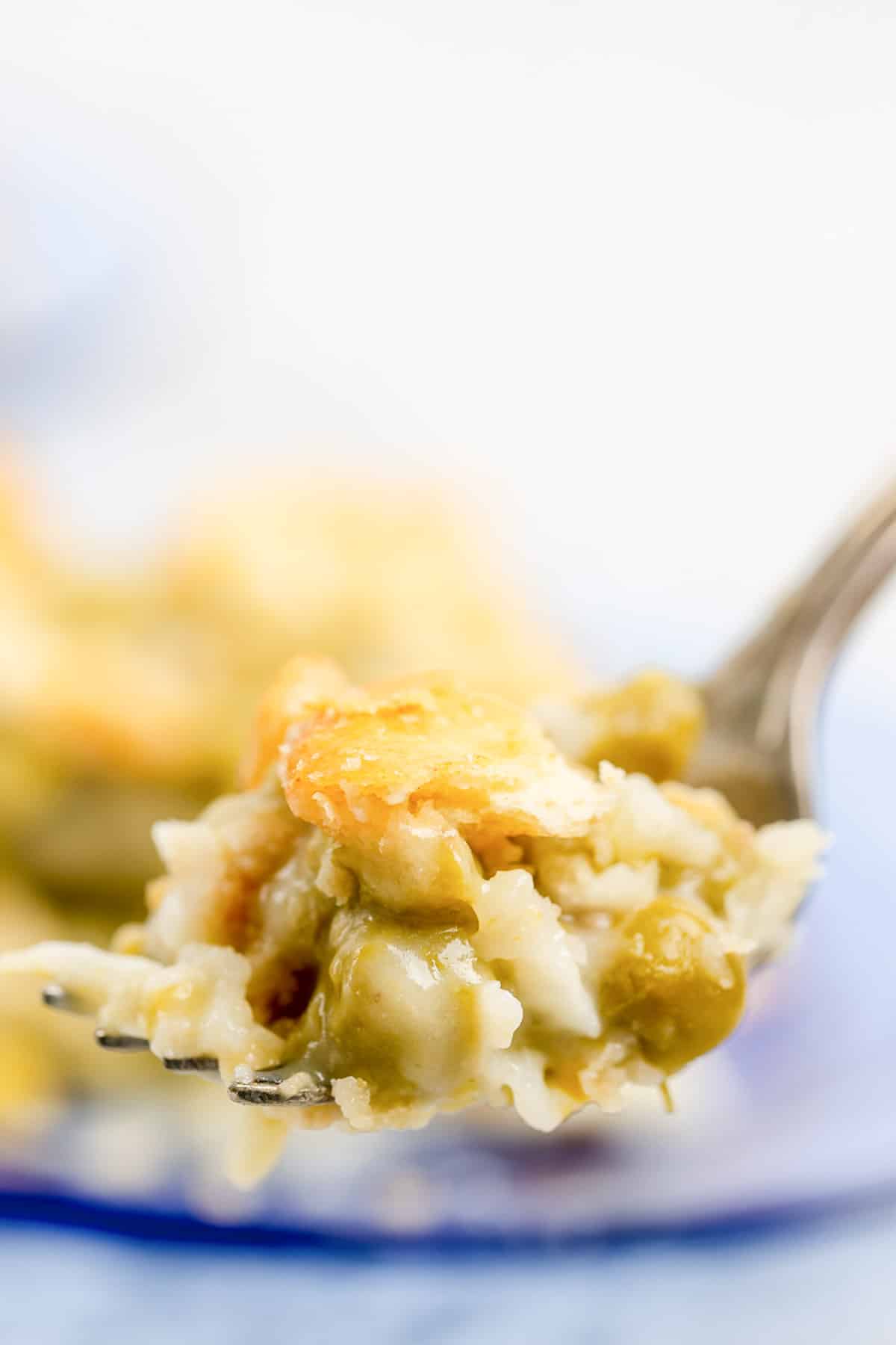 Canned asparagus casserole with eggs on a fork.