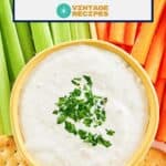 Overhead view of New England clam chowder dip, crackers, carrot sticks, and celery.