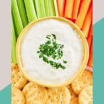 Overhead view of New England clam chowder dip, celery, carrots, and crackers.