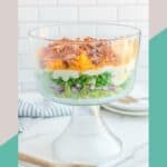 Seven layer salad in a trifle dish.