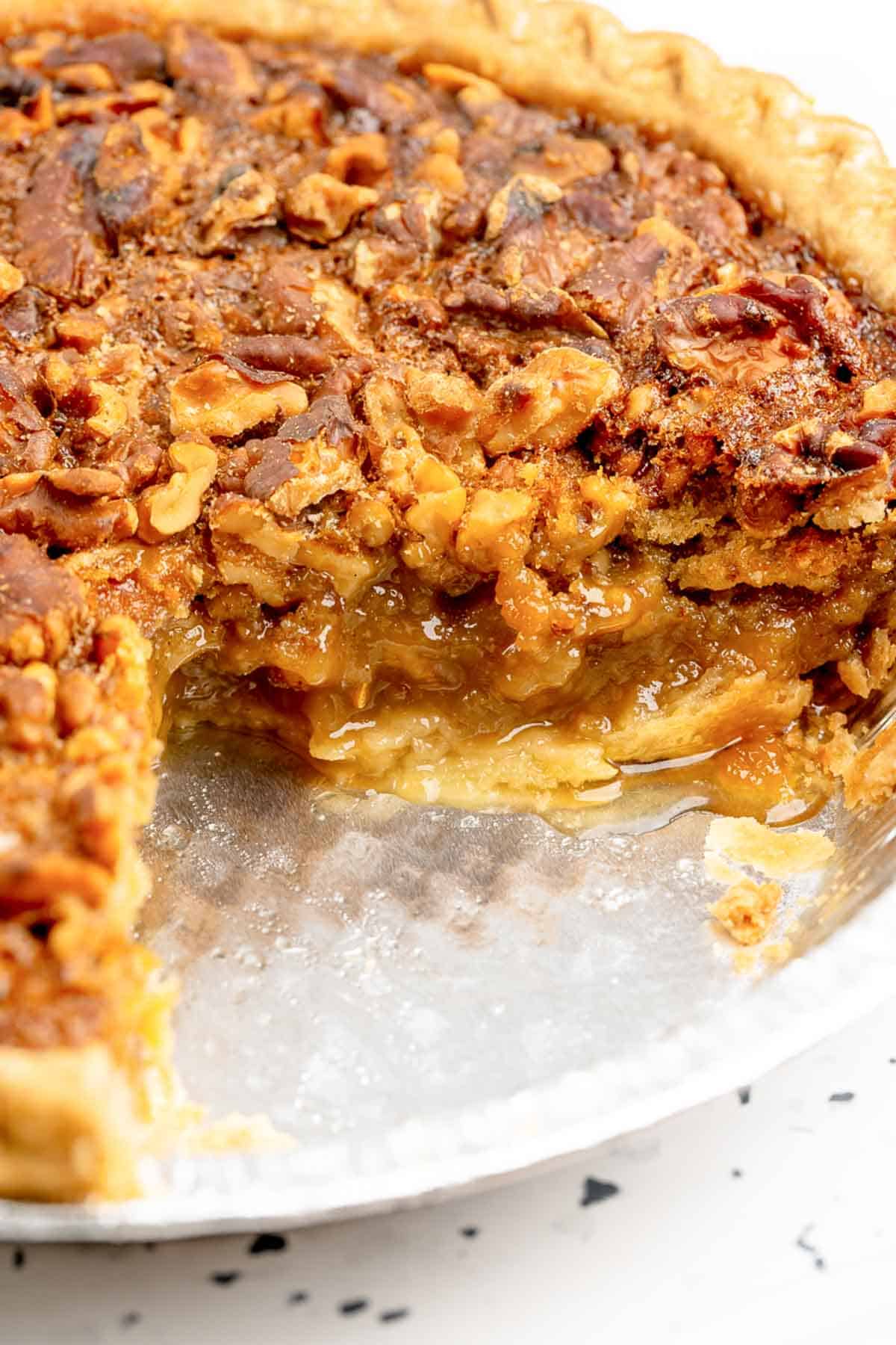 Walnut pie with a slice out of it.