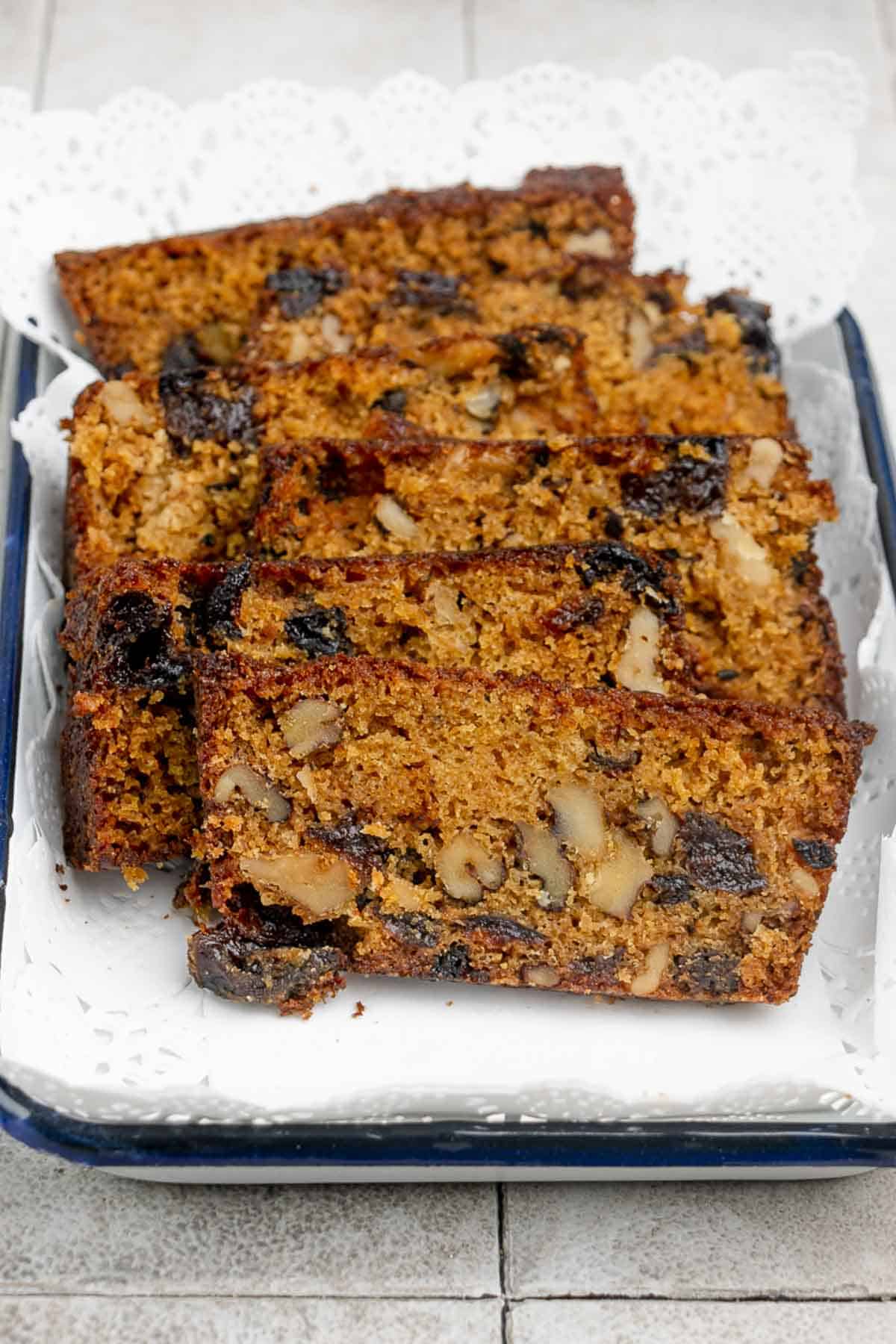 Homemade prune bread with walnuts on a serving tray.