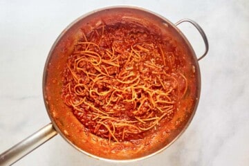 Spaghetti and meat sauce in a skillet.
