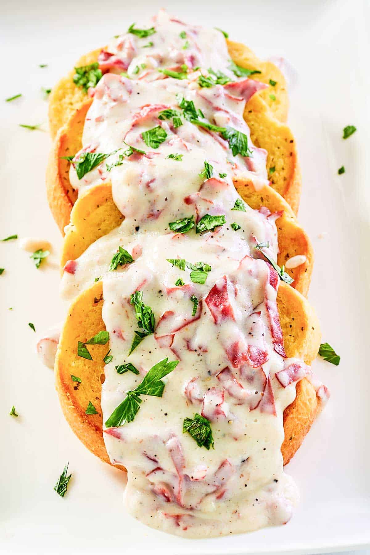 Creamed chipped beef on toast on a white platter.