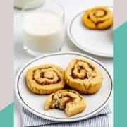 Date pinwheel cookies on plates and a glass of milk.