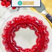 Cranberry jello salad made in a jello ring on a platter.