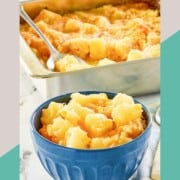 Pineapple cheese casserole serving in a bowl with the dish behind it.