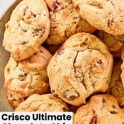 Homemade Crisco chocolate chip cookies piled on a plate.