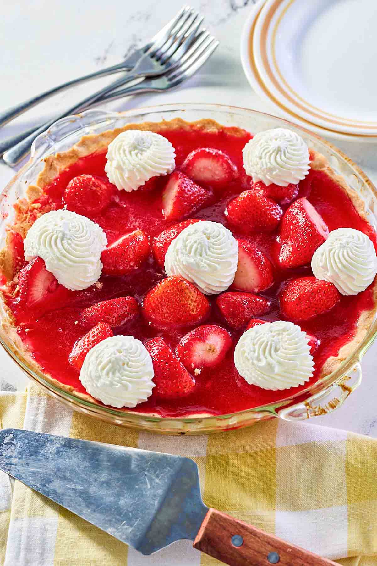 Old fashioned strawberry pie in a glass pie plate.