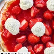 Strawberry pie garnished with whipped cream.