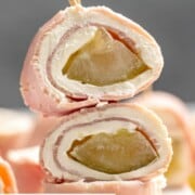 A stack of ham and pickle roll ups.