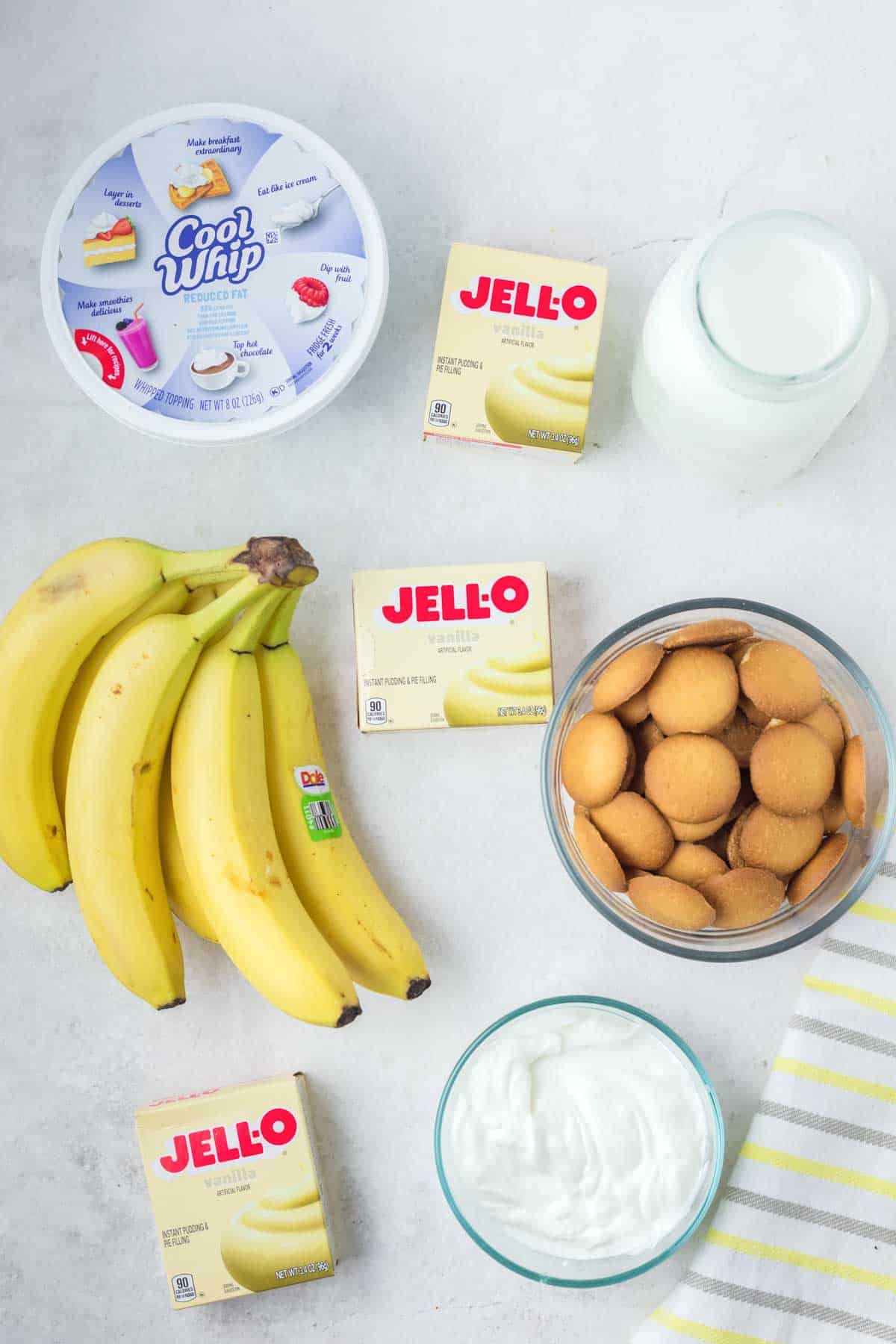 Sour cream banana pudding ingredients on a marble surface.