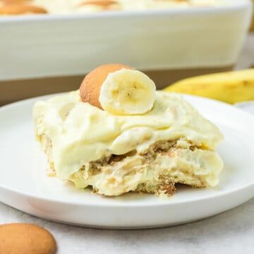 Banana pudding with sour cream serving on a plate.
