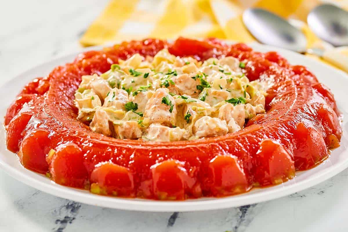 Tomato aspic served with shrimp salad in the center.