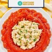 Tomato aspic made in a round jello mold with shrimp salad in the center.