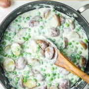 Creamed peas and potatoes in a large skillet.