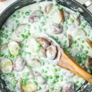 A skillet of creamed peas and potatoes.