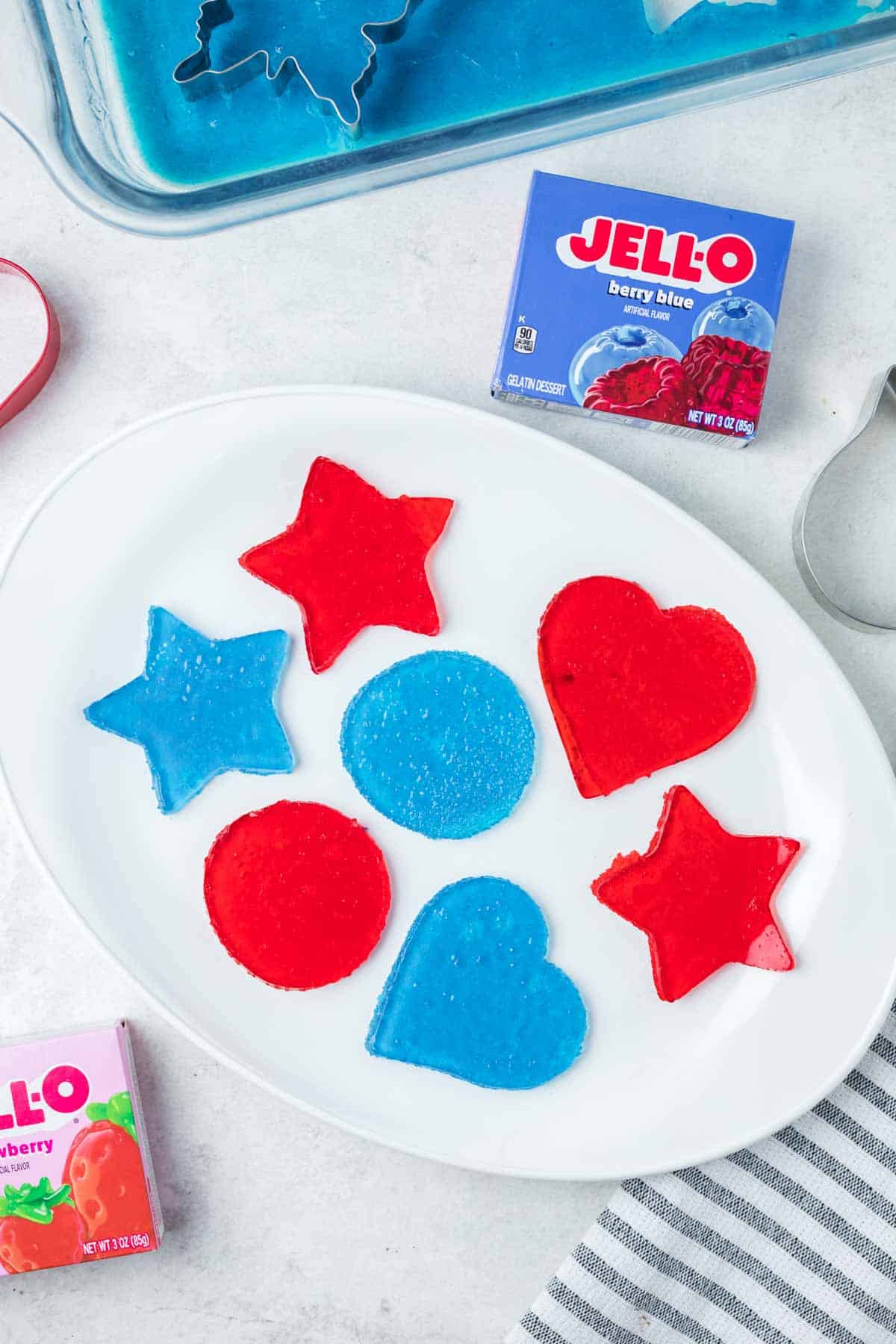 Jello jigglers in assorted flavors and shapes on a plate.