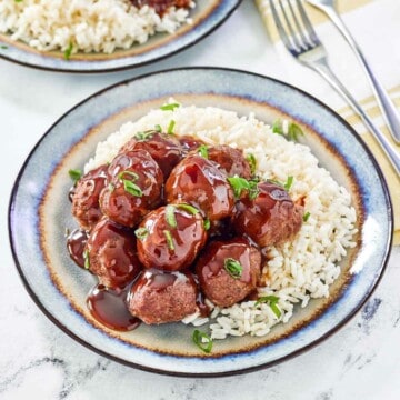 Sweet and sour meatballs and rice on a plate.